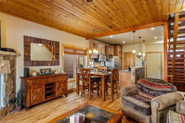 living room with light hardwood / wood-style flooring and wood ceiling