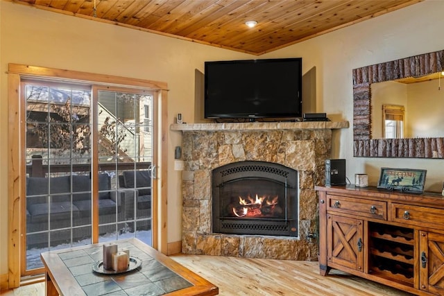 sitting room featuring hardwood / wood-style floors, wooden ceiling, and a fireplace