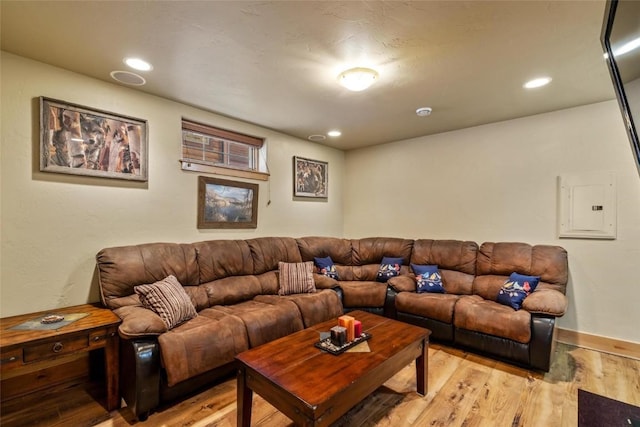 living room featuring electric panel and light wood-type flooring