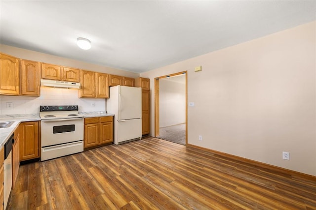 kitchen featuring backsplash, dark hardwood / wood-style floors, and white appliances