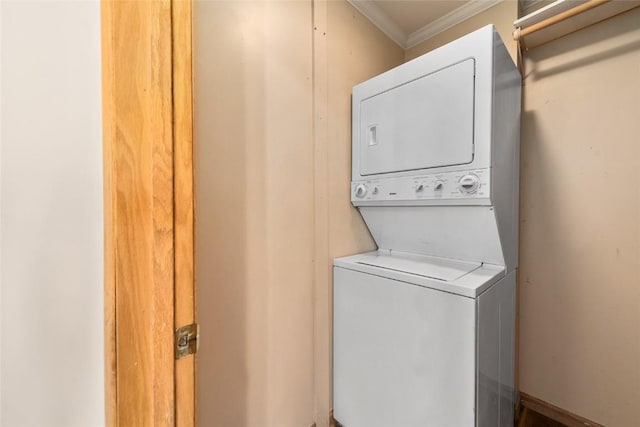 laundry room with stacked washing maching and dryer and ornamental molding