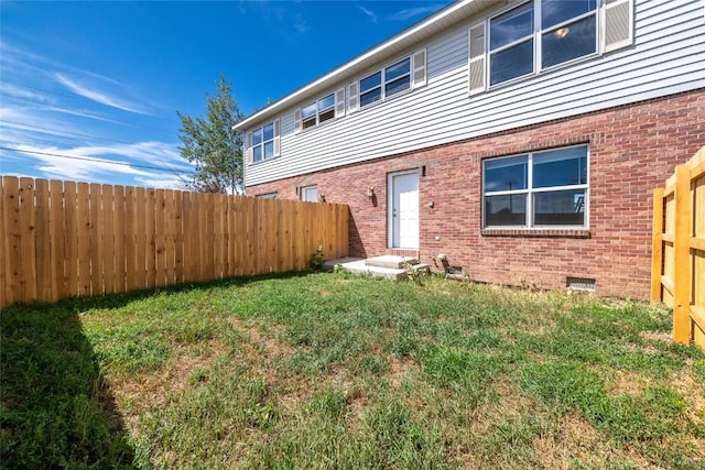 back of house with a lawn