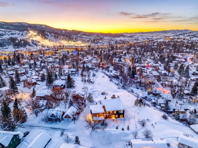 snowy aerial view with a mountain view