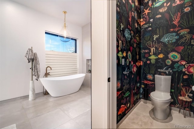 bathroom with a tub, tile patterned floors, and toilet