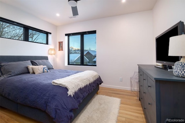 bedroom with ceiling fan and light hardwood / wood-style floors