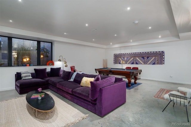 living room with a tray ceiling and billiards