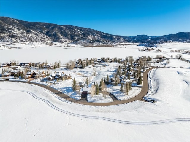 snowy aerial view featuring a mountain view