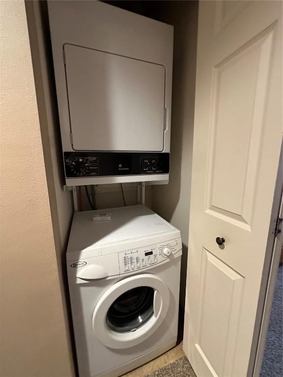 laundry area with stacked washing maching and dryer