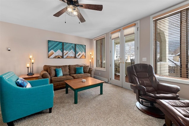 carpeted living room with ceiling fan and french doors