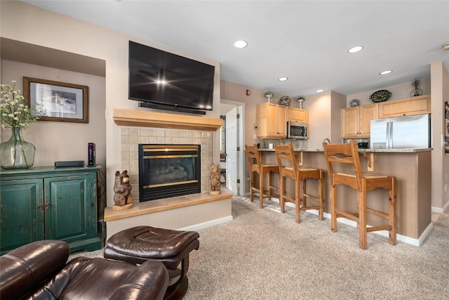 living room with light carpet and a fireplace