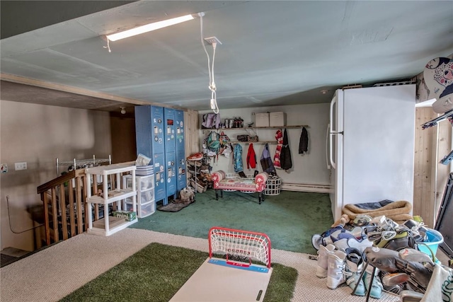 basement with white fridge and carpet flooring