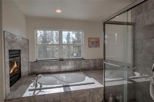 bathroom with a fireplace and plus walk in shower