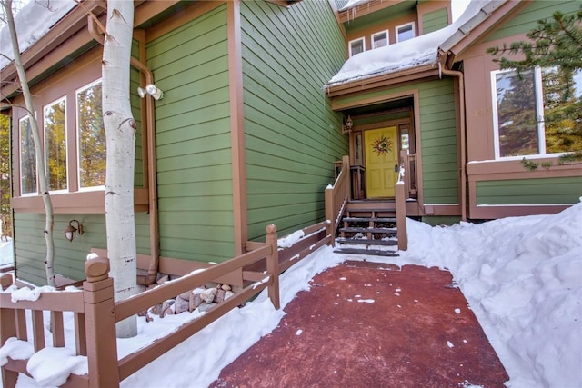 view of snow covered property entrance