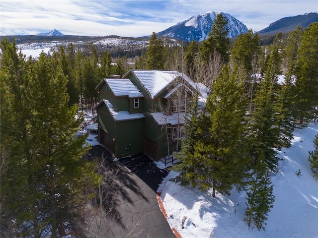 snowy aerial view with a mountain view