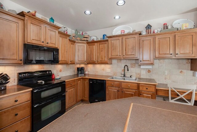 kitchen featuring decorative backsplash, sink, and black appliances