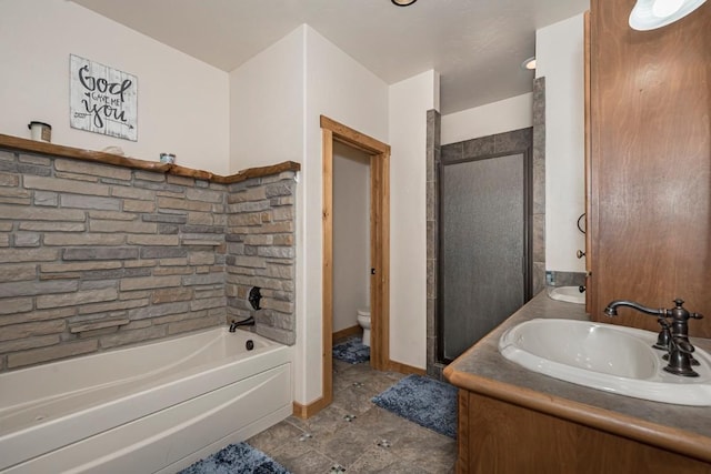 full bathroom featuring vanity, toilet, and shower with separate bathtub