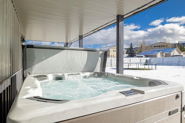 snow covered patio with a hot tub