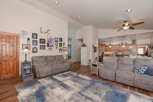 living room featuring hardwood / wood-style flooring, ceiling fan, and lofted ceiling