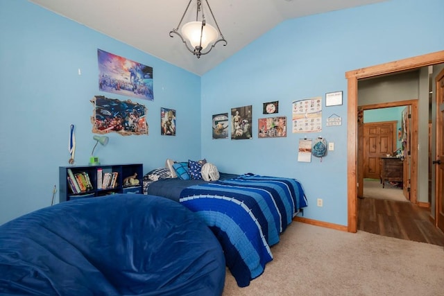 carpeted bedroom with vaulted ceiling