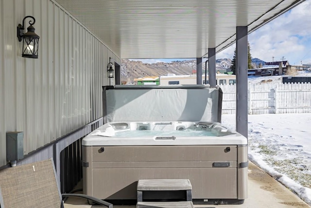 snow covered patio featuring a hot tub