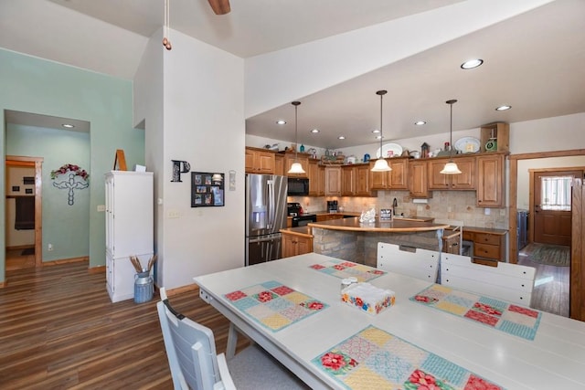 dining room with dark hardwood / wood-style floors and sink