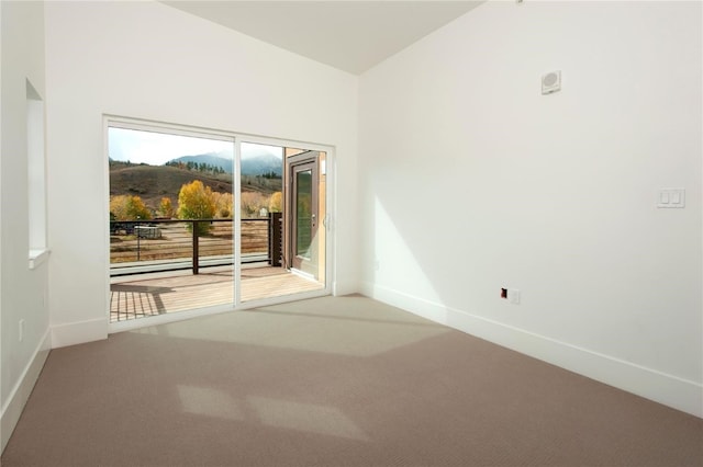 carpeted spare room featuring a healthy amount of sunlight