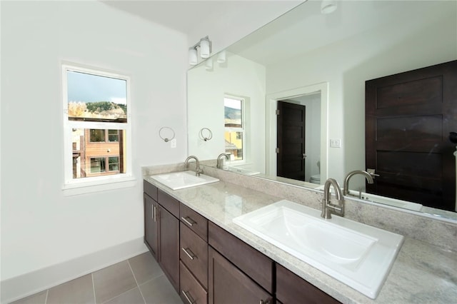 bathroom featuring tile patterned floors, vanity, and toilet