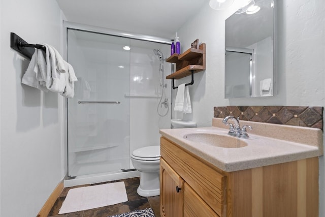 bathroom with vanity, toilet, and an enclosed shower