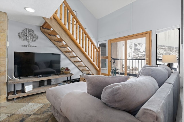 living room featuring a towering ceiling