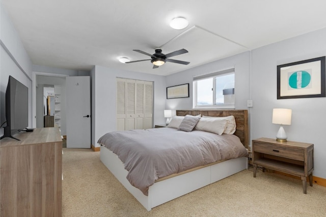 bedroom with light carpet, a closet, and ceiling fan