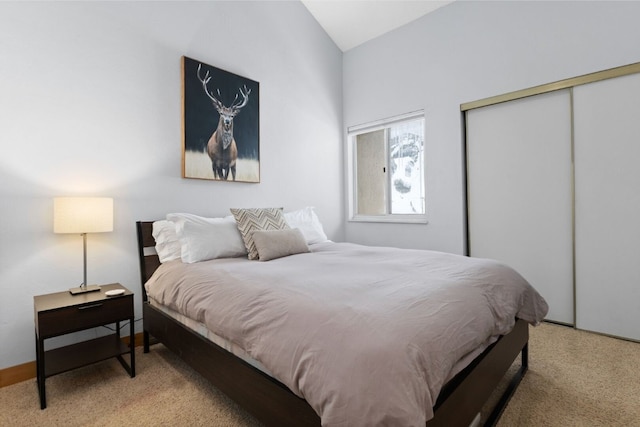 bedroom with lofted ceiling and a closet