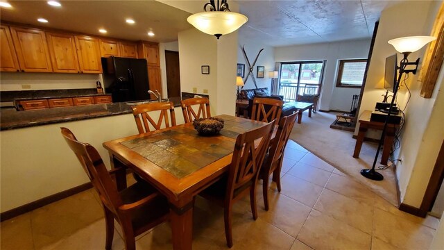 dining room with sink and light tile patterned floors