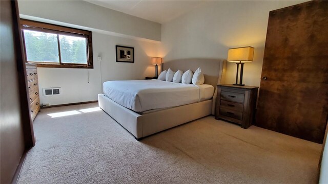 bedroom featuring light carpet