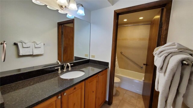 full bathroom featuring tile patterned flooring, vanity, toilet, and washtub / shower combination