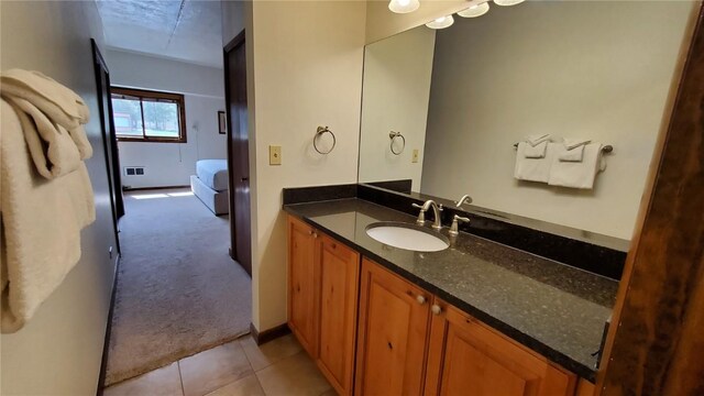 bathroom with vanity and tile patterned flooring