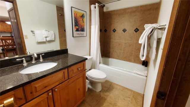 full bathroom with vanity, tile patterned flooring, toilet, and shower / bath combo with shower curtain