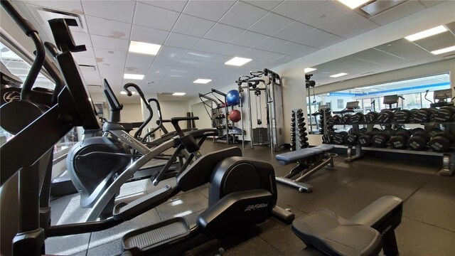 exercise room featuring a drop ceiling