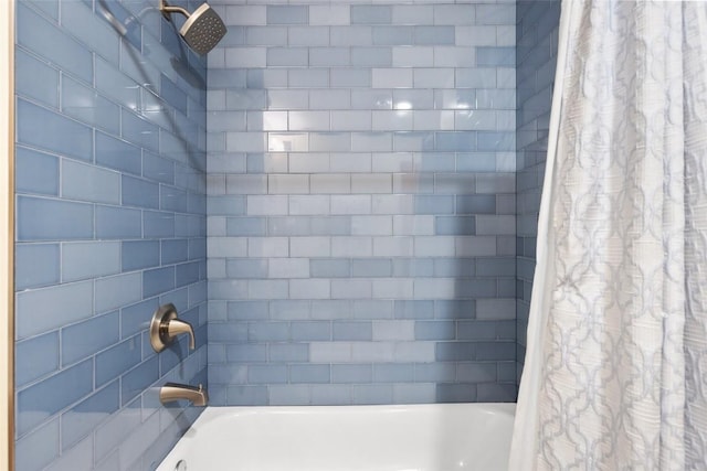 bathroom with shower / bath combo with shower curtain