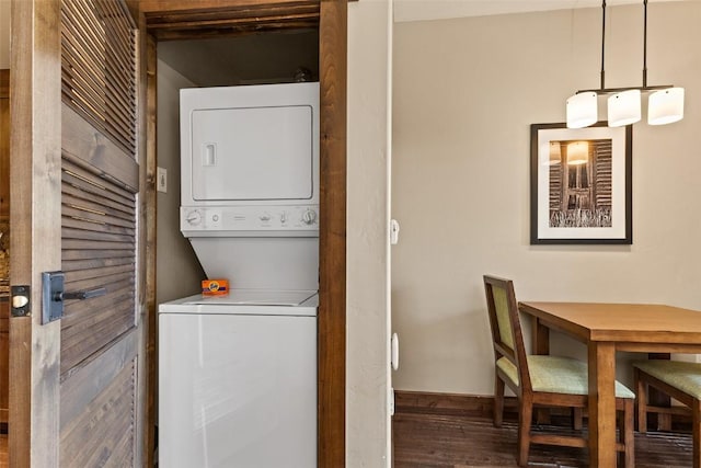 clothes washing area featuring dark hardwood / wood-style flooring and stacked washer and dryer