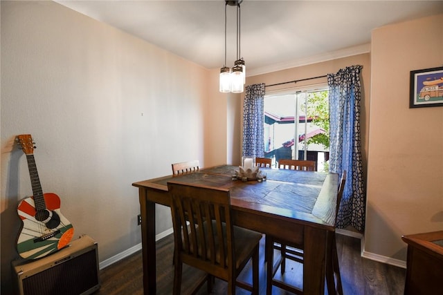 dining room featuring ornamental molding and dark wood-type flooring