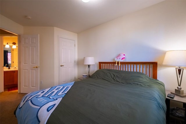 carpeted bedroom featuring connected bathroom