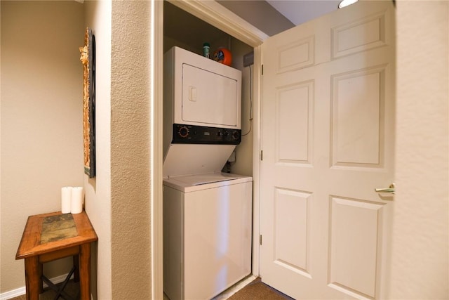 clothes washing area with stacked washer and clothes dryer