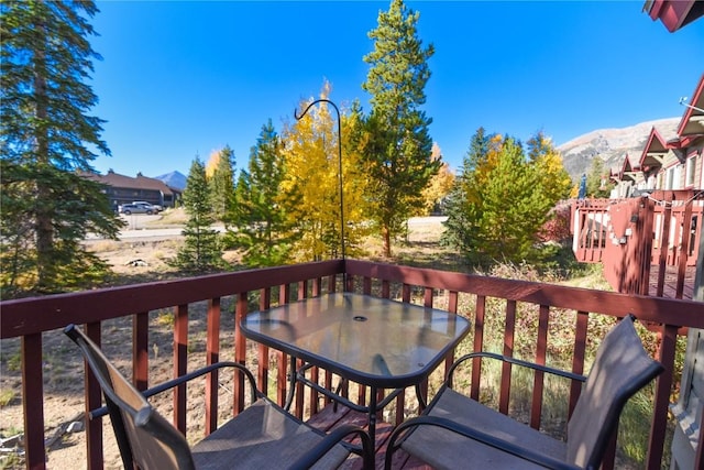 wooden deck with a mountain view