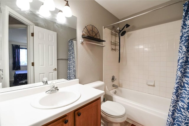 full bathroom with vanity, toilet, and shower / tub combo with curtain