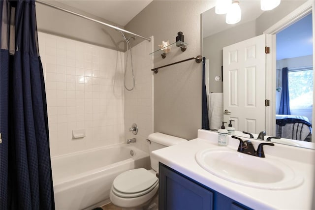 full bathroom with vanity, shower / bath combo, and toilet