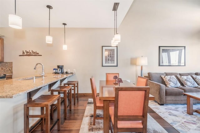 dining space with hardwood / wood-style flooring and sink