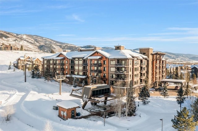 snow covered property with a mountain view