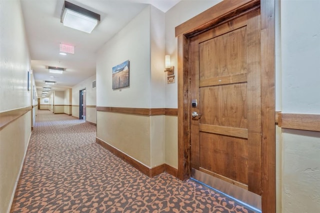 hallway featuring dark carpet