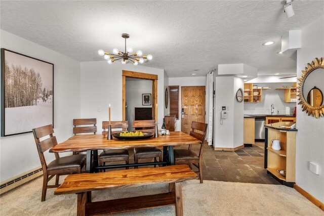 carpeted dining space with an inviting chandelier, sink, a textured ceiling, and baseboard heating