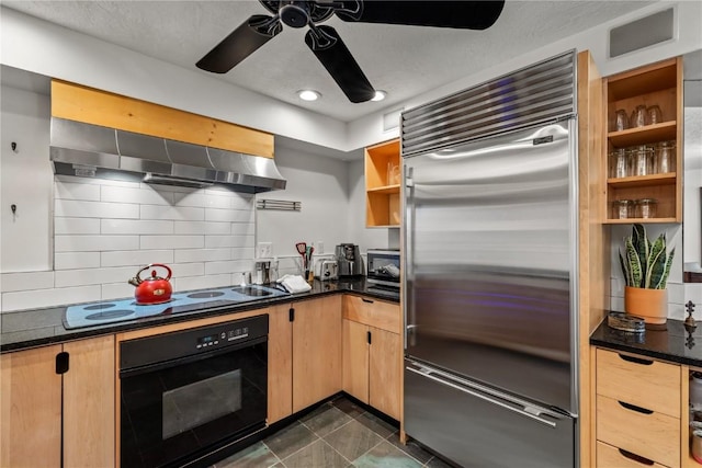 kitchen featuring dark tile patterned floors, ceiling fan, backsplash, ventilation hood, and black appliances